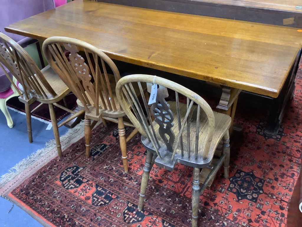 A modern kitchen refectory table, and three wheel back dining chairs (4)